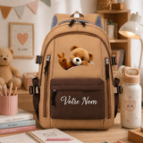 Sac à dos ours personnalisé avec prénom brodé, posé sur un bureau